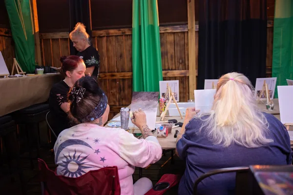 Guests working on their canvases together