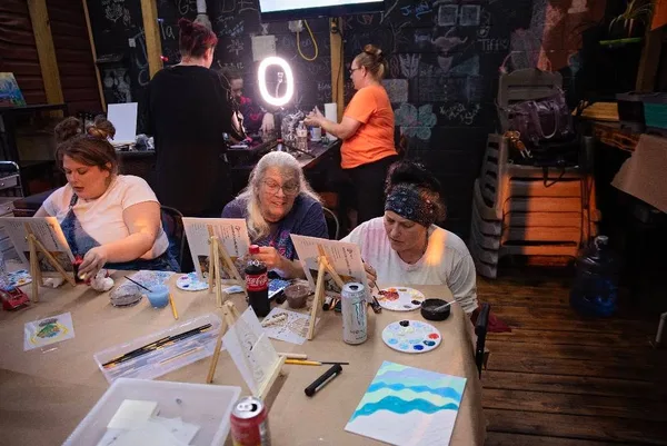 A table full of artists and works in progress