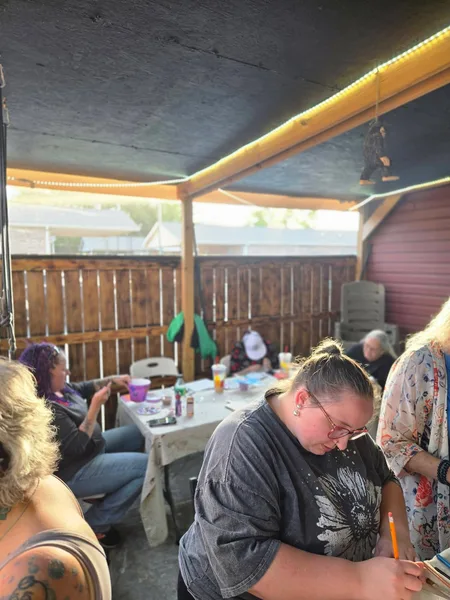 Guests painting together on the patio