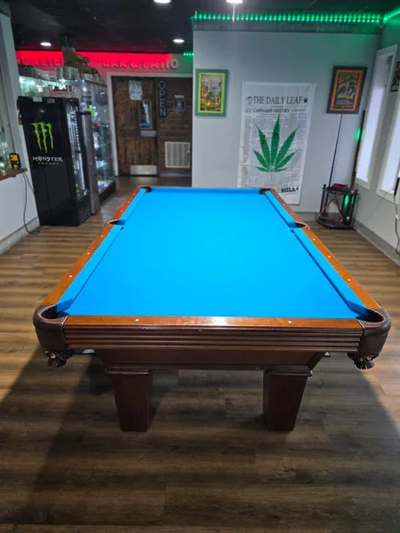 The pool table with its new blue felt, August 2026
