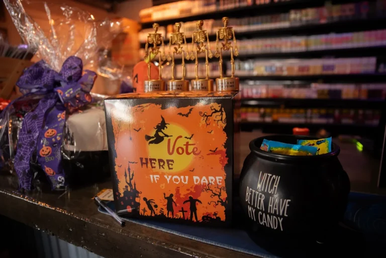 Halloween decorations and candy display at the store counter.