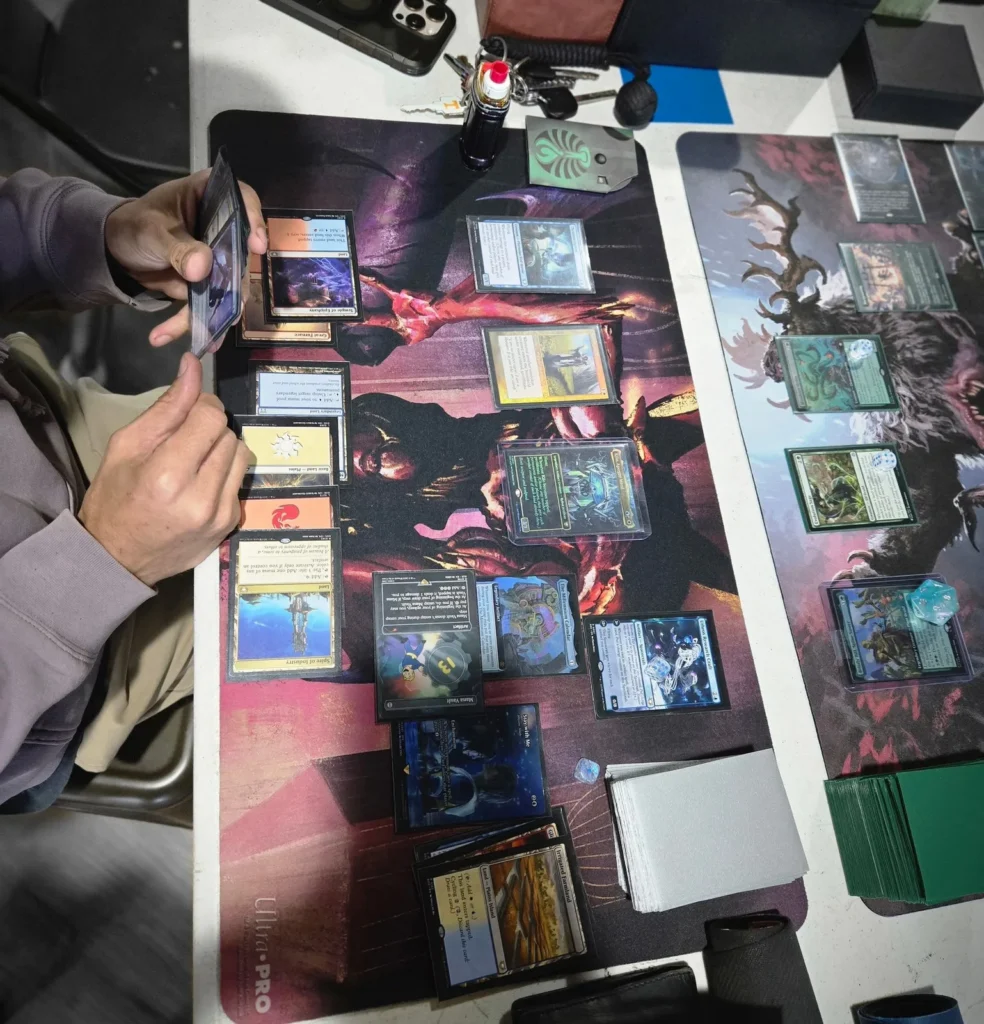 Close view of players and cards during a Magic: The Gathering game.