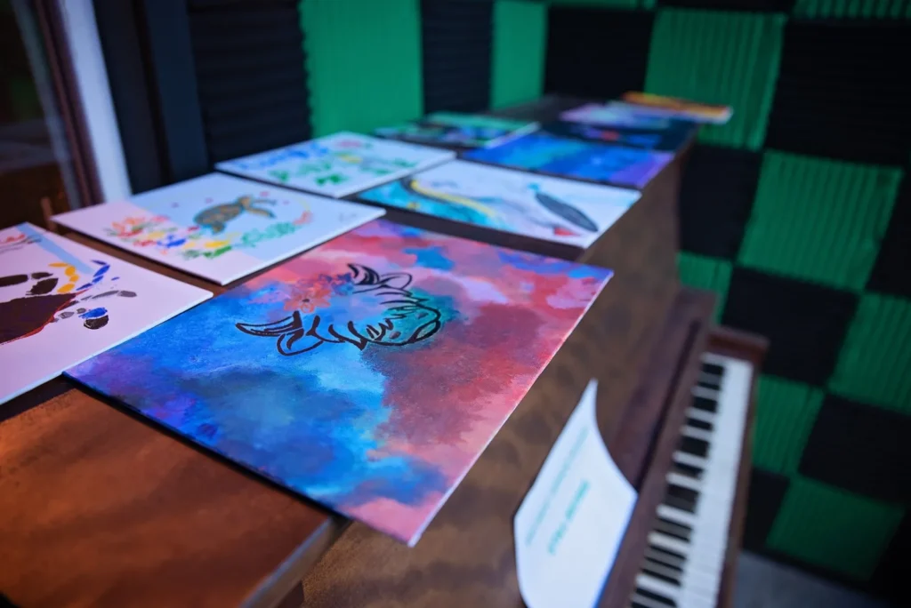 Several finished paintings arranged on a table.
