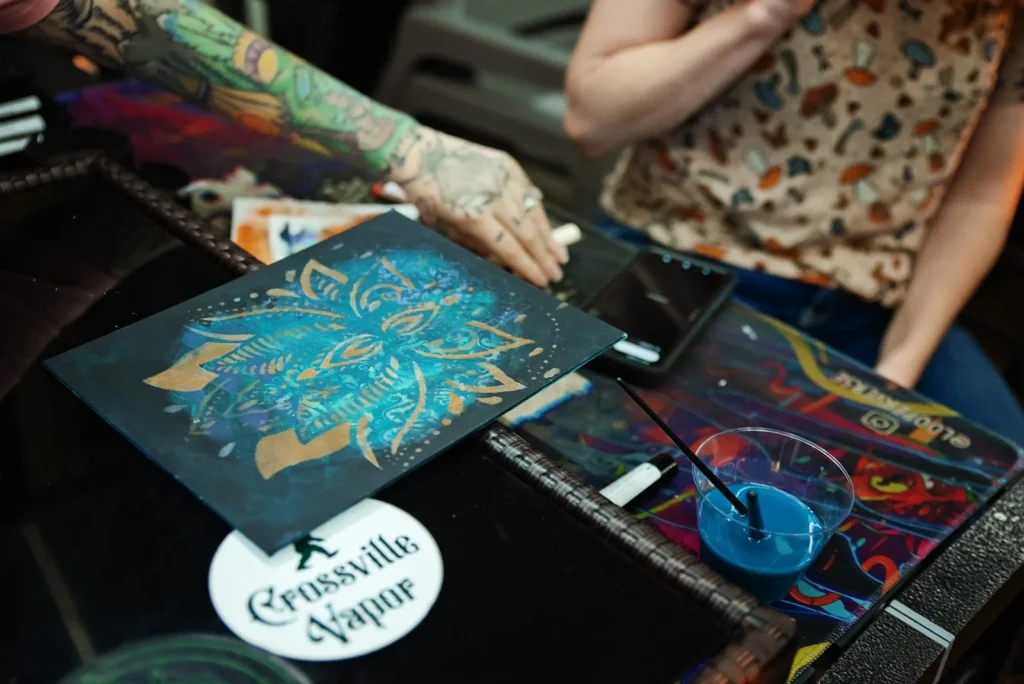 Participant displays a finished painting.